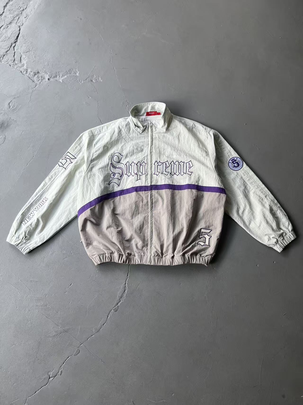 High-end sup x umb collaboration football jacket – casual, minimalist, and stylish zip-up turtleneck